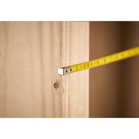 STANLEY 0-39-055 tape measure measuring wooden board, close-up photo