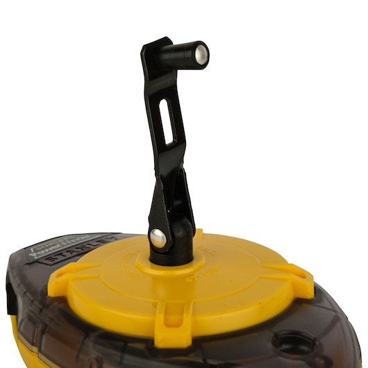 STANLEY 0-47-465 chalk reel with yellow body and black crank handle, close-up angled view on white background.