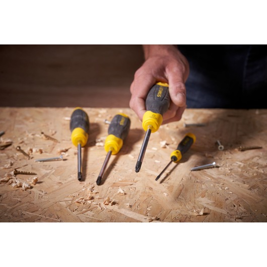 Photo of STANLEY 0-64-974 screwdriver set with yellow and black handles on a plywood surface.
