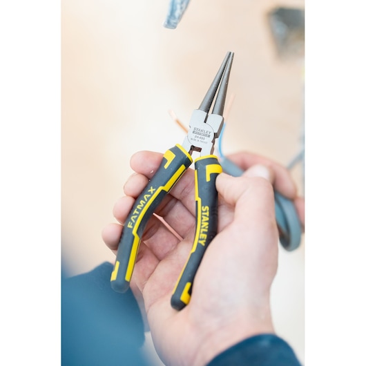 STANLEY 0-84-496 FATMAX long nose pliers with yellow and black handle, close-up in hand.
