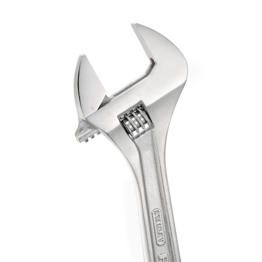 Close-up of a silver adjustable wrench with measurement markings on the jaw, STANLEY brand.