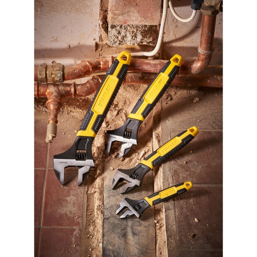 STANLEY 0-90-947 adjustable wrenches set with yellow and black handles on construction site.