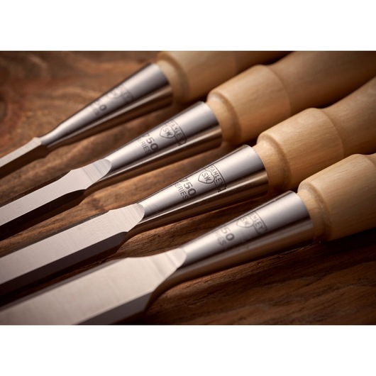 STANLEY 1-16-793 woodworking chisels with wood handles, close-up angle on wooden surface.