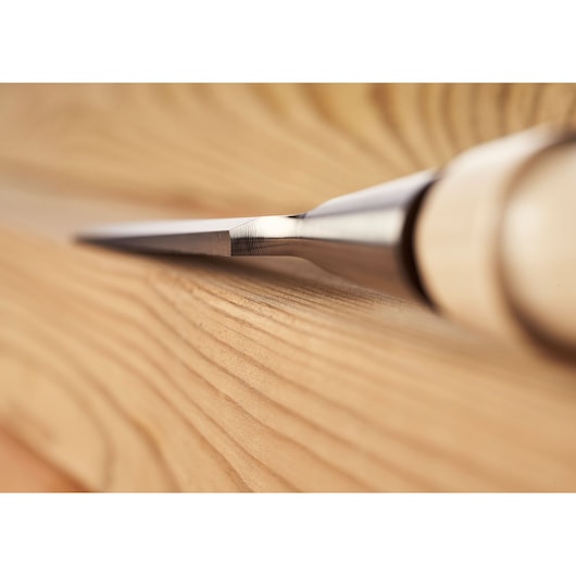 STANLEY 1-16-793 wood chisel with sharp blade, close-up photography on smooth wooden surface.