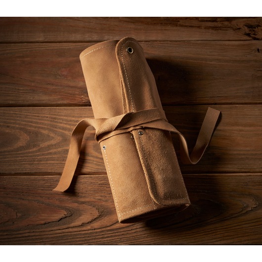 STANLEY 1-16-793 leather tool roll, rolled and tied, photography on wooden background.