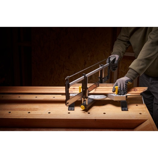 STANLEY 1-20-800 hand mitre saw in use on wooden workbench, cutting angled wood piece.