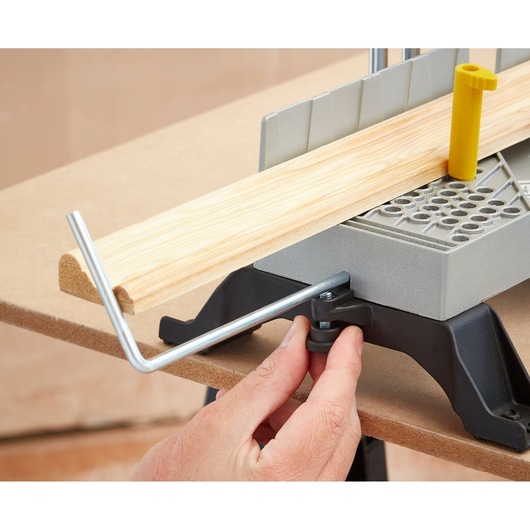 STANLEY 1-20-800 miter box with saw guide, wood piece positioned, close-up angle on white background.