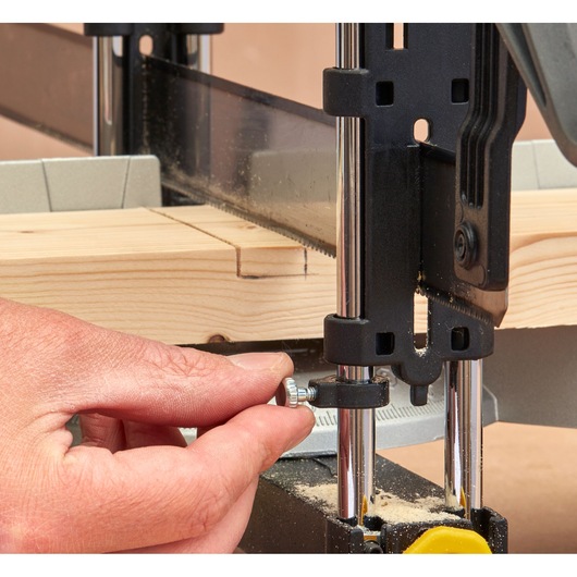 STANLEY 1-20-800 photography of a hand adjusting a bandsaw guide on a piece of wood, close-up angle.