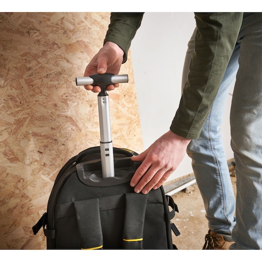 STANLEY 1-79-215 tool backpack with telescopic handle, shown from above in use.