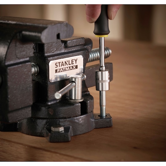 STANLEY 1-83-065 bench vice in use with hand tool on wooden surface, close-up angle.