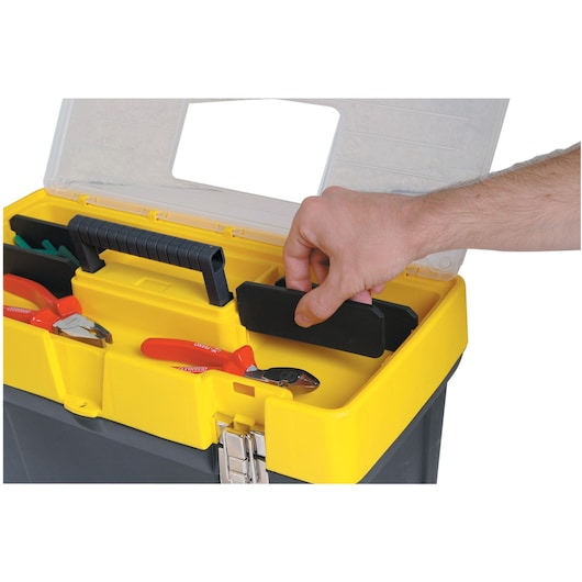 STANLEY 1-93-285 toolbox with yellow tray, black handle, and hand accessing compartment, top angle.