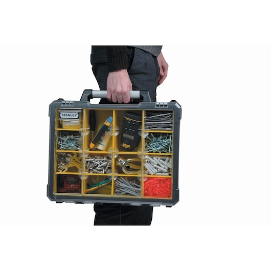 STANLEY 1-93-293 organizer case with compartments, filled with various hardware, shown carried by hand, front angle.