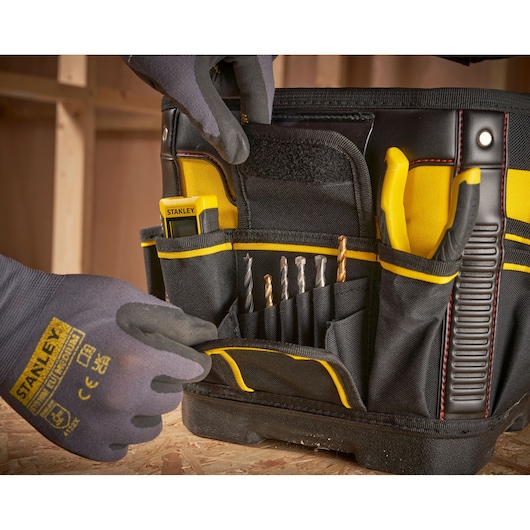 STANLEY 1-93-952 tool bag photography showing organized drill bits, pliers, and tape measure in exterior pockets.