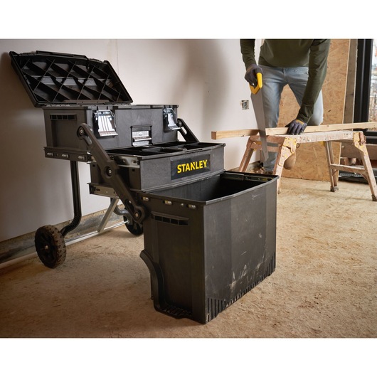 Photo of STANLEY 1-94-210 mobile toolbox with open compartments in a workshop setting.