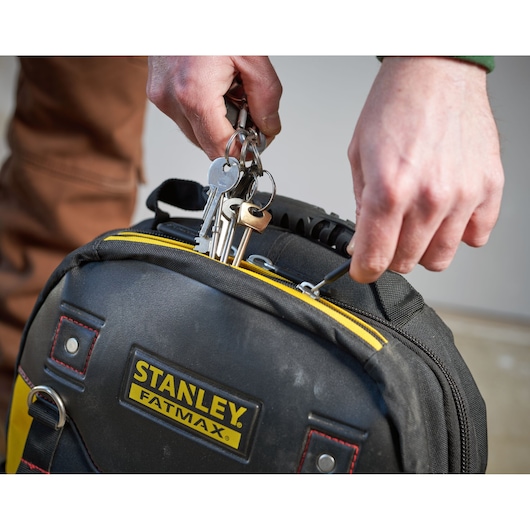 STANLEY 1-95-611 FatMax tool bag, black with yellow details, close-up of zip being opened.