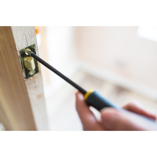 STANLEY FMHT0-62064 screwdriver used to install door lock, close-up photography.