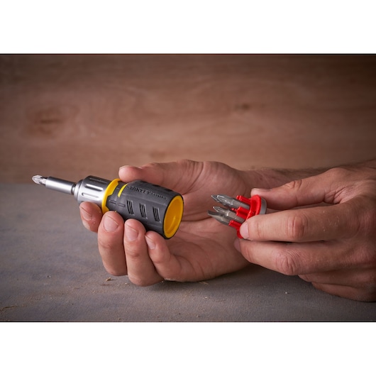 STANLEY FMHT0-62688 screwdriver with bit holder in hand, photography showing product features.