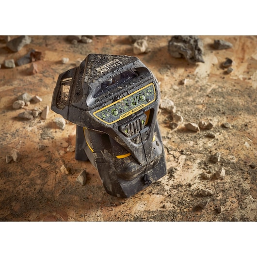 STANLEY FMHT1-77356 rugged black and yellow laser level on dusty construction floor.