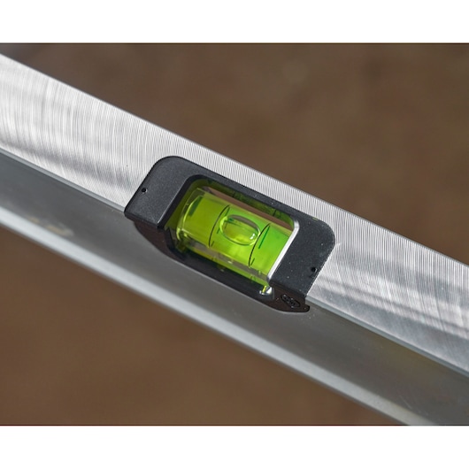 STANLEY FMHT43673-1 spirit level close-up, silver body with green vial, photography.