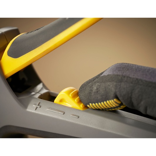 STANLEY FMHT6-70868 photography, close-up of gloved hand adjusting yellow feature on tool handle.