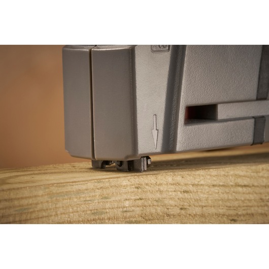 STANLEY FMHT6-70868 staple gun close-up resting on wooden surface, photography side angle.