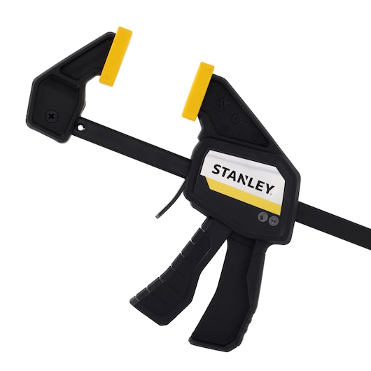 STANLEY FMHT83271-0 photography of black and yellow trigger clamp, side angle on white background.