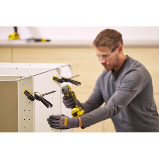 STANLEY FMHT83272-0 photography of bar clamps securing cabinet panels during assembly.