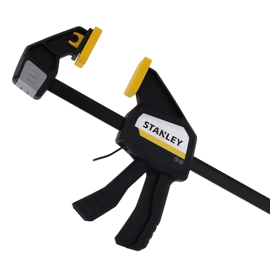 STANLEY FMHT83276-0 photography of black and yellow trigger clamp at angled view on white background.