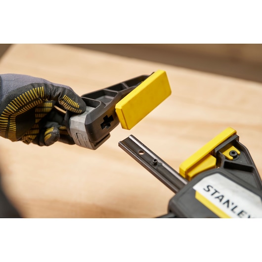 Stanley FMHT83280-0 photography of one-handed clamp with removable yellow jaw, close-up view.