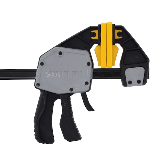 STANLEY FMHT83282-0 photography of trigger clamp with black and yellow jaws, side angle on white background.