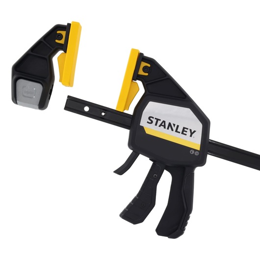 STANLEY FMHT83283-0 photography of black and yellow trigger clamp on white background, side angle.