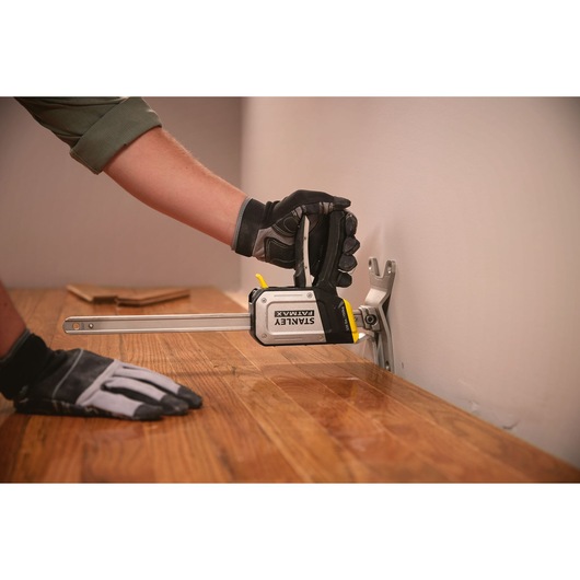 Photo of STANLEY FMHT83550-1 clamp holding wood flooring in place during installation.
