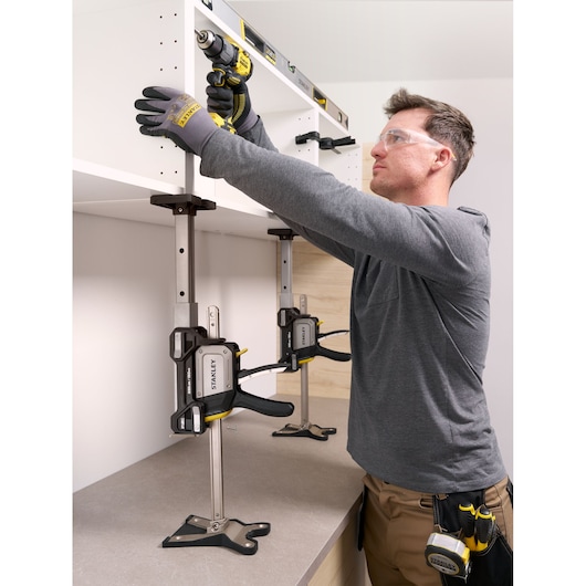 Photo of STANLEY FMHT83554-1 support clamp used to hold a cabinet in place during installation, shown from a side angle.
