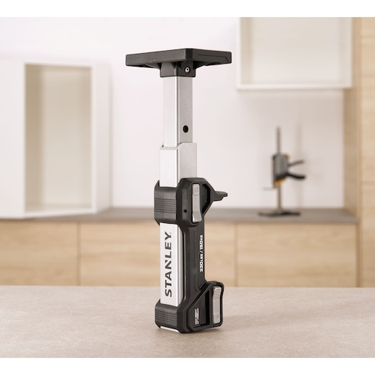STANLEY FMHT83554-1 telescopic support bar on tabletop, silver and black, upright front angle.