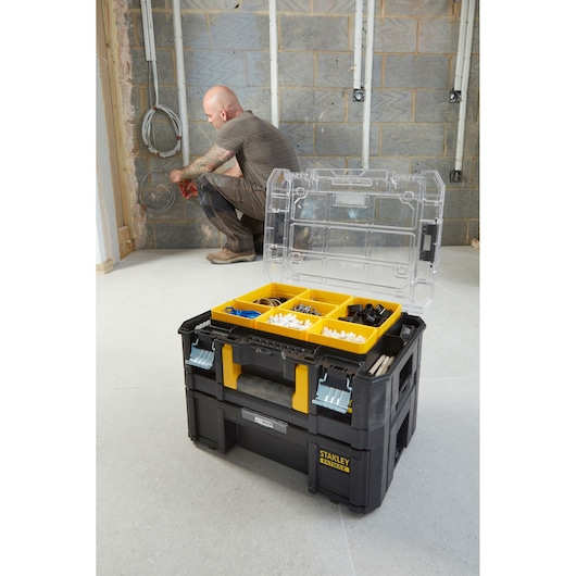 STANLEY FMST1-71970 tool organizer box with open clear lid, yellow compartment tray, shown in workspace.