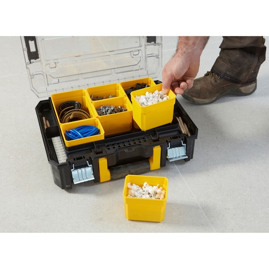 STANLEY FMST1-71970 toolbox with yellow removable compartments on floor, open top view.