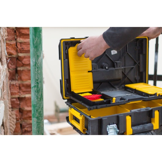 STANLEY FMST1-75679 black and yellow toolbox open, interior compartments visible, hand organizing tools.