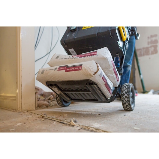 STANLEY FMST1-75683 photography of heavy-duty trolley carrying cement bags and toolbox on construction site