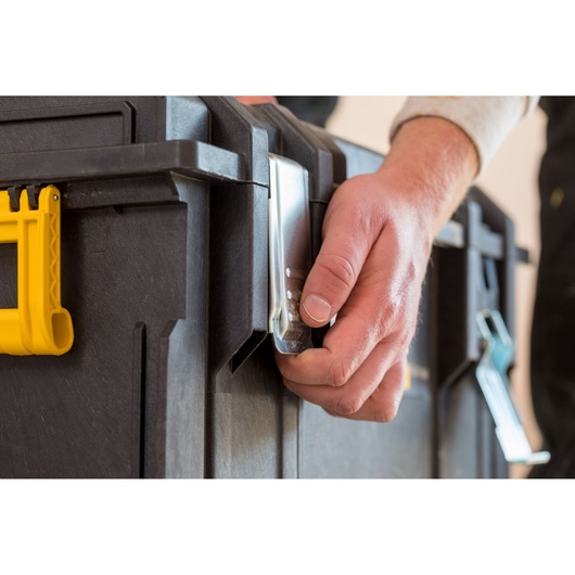Stanley FMST1-75798 toolbox front angle, hand opening metal latch with yellow handle visible.