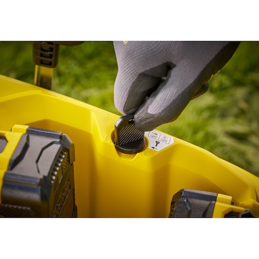 STANLEY SCMWP3701N photography showing gloved hand turning yellow power tool key outdoors.