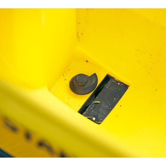 STANLEY STCOE300D1 photography of yellow equipment with black knob and debris, close-up angle.