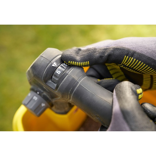 STANLEY STCOE300D1 photography of a gloved hand adjusting a dial on a power tool handle.