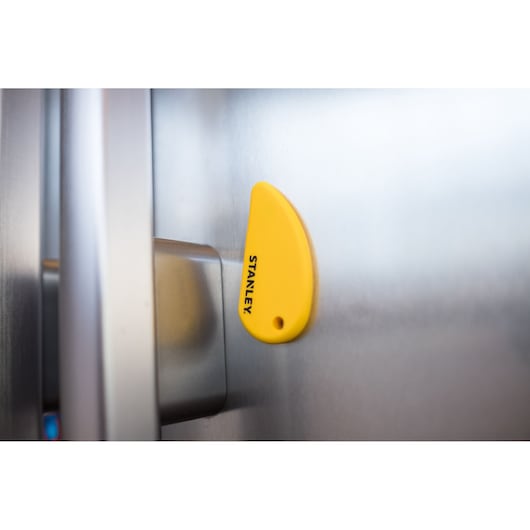 STANLEY STHT0-10291 yellow magnetic tool holder on a metallic surface, product close-up.