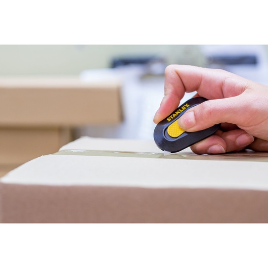 Photo of STANLEY STHT0-10292 utility cutter being used to open a cardboard box.