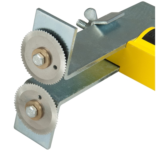 Close-up of a Stanley tool with two metal gear wheels and yellow handle for sheet metal cutting.