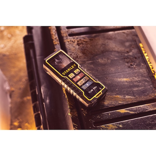 STANLEY STHT1-77343 photography of TLM 99s laser distance measurer on a dirty work surface