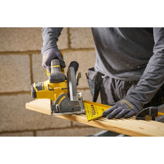STANLEY STHT46012-0 yellow plastic rafter square used for marking wood, shown in use with circular saw.