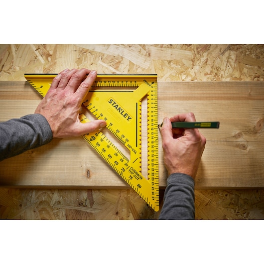 STANLEY STHT46013-0 yellow carpenter's square on wood in use, top view photography.