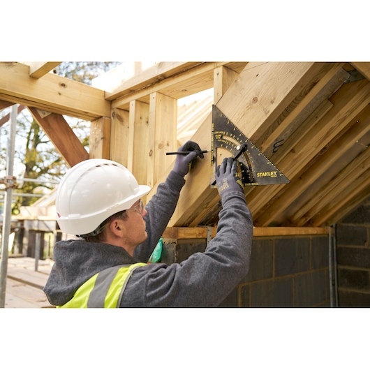 STANLEY STHT46054-0 roofing square used to mark angles on timber during roof construction.