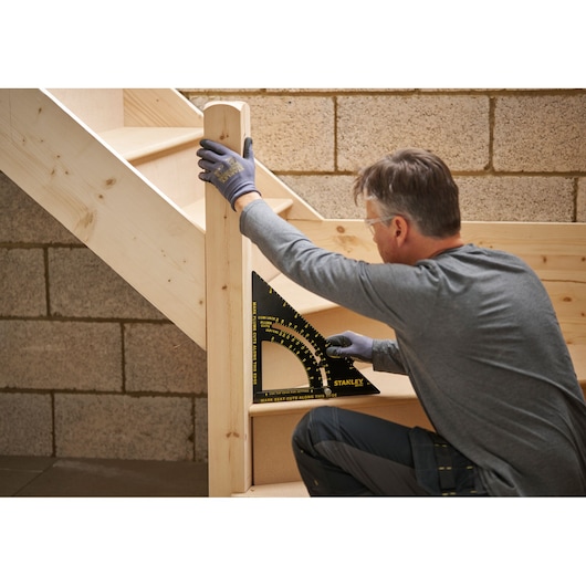 STANLEY STHT46054-0 protractor square used to measure wooden staircase angle.